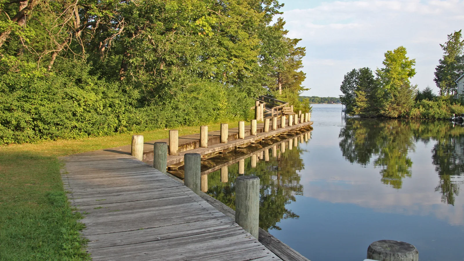 Wooden boardwalk along a quiet lake channel in Southeast Wisconsin