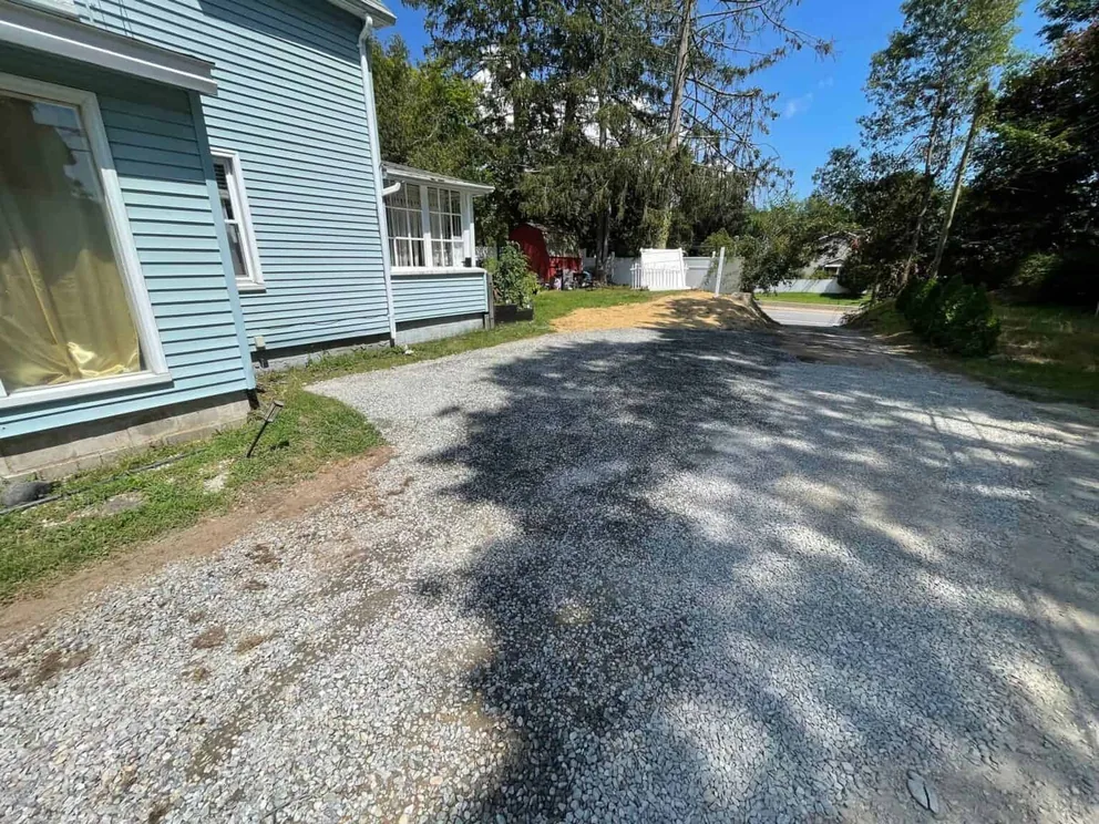 Gravel driveways: a new drive freshly spread beside a house out to the road